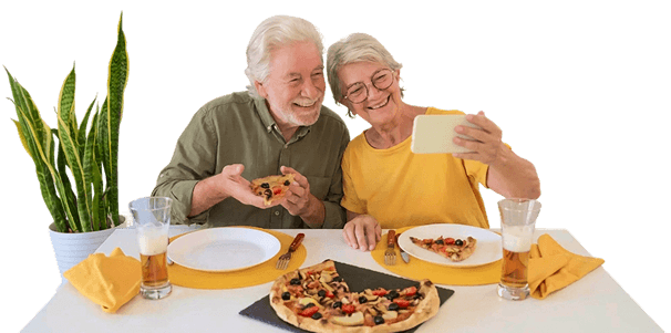 Elderly Couple Taking Selfie While Eating Pizza in Independent Living Facility
