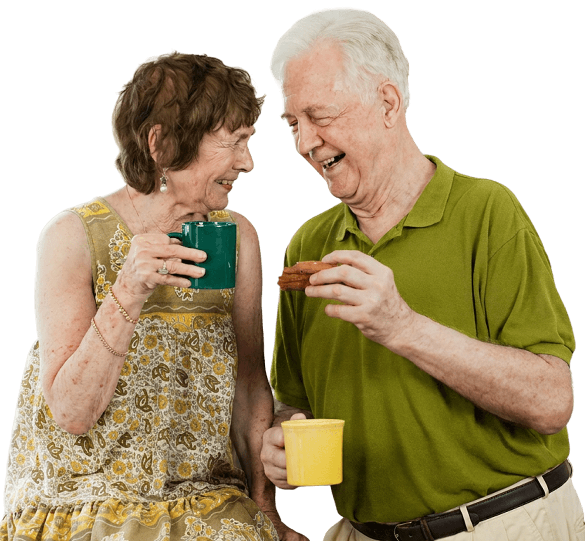 Elderly Couple Enjoying Coffee And Snacks Together in Independent Living Facility Elderly Couple Enjoying Coffee And Snacks Together in Independent Living Facility