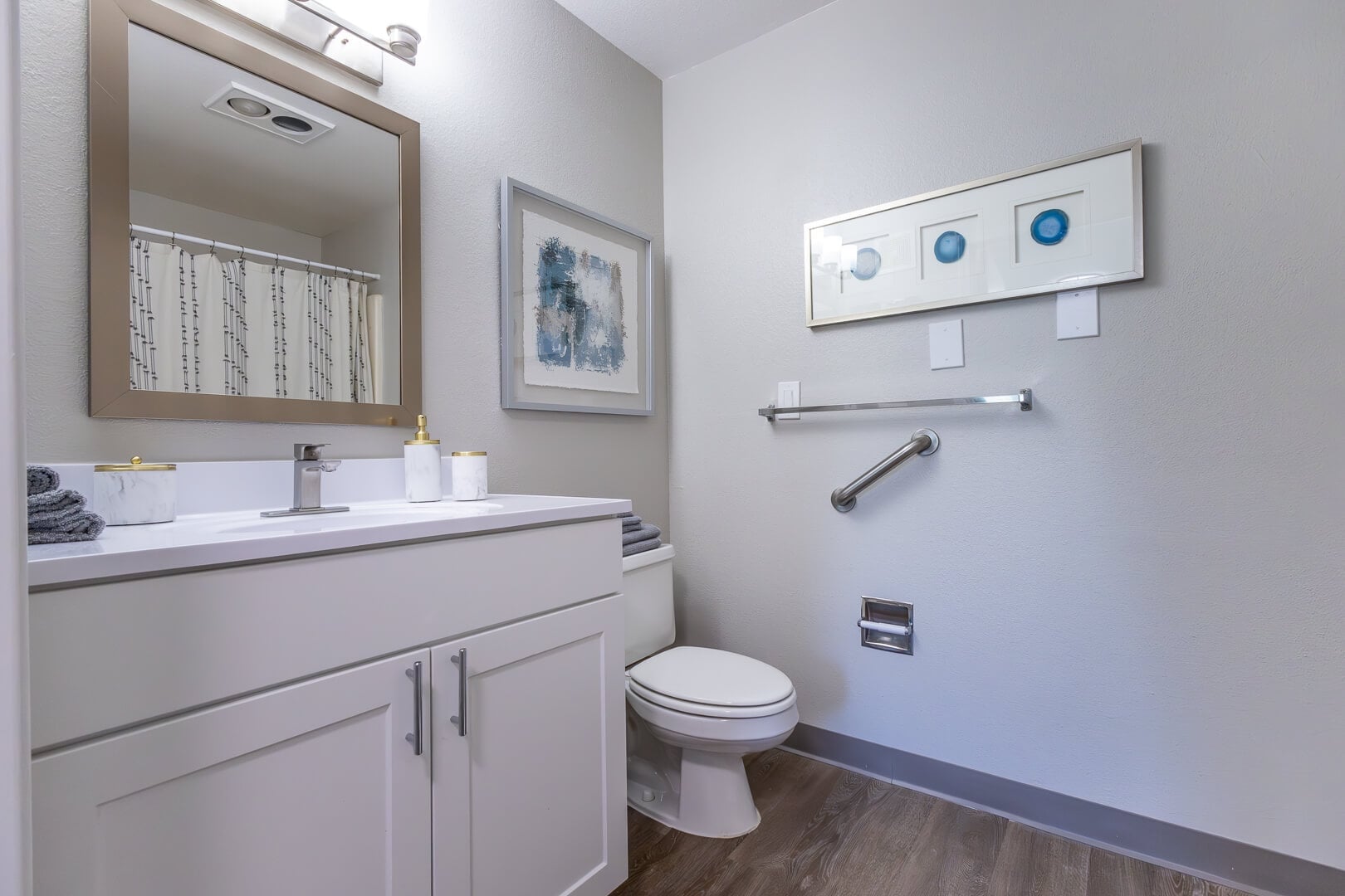 Clean Bathroom with Safety Grab Bar and White Vanity in Independent Living