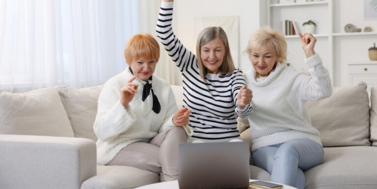 Elderly Friends Celebrating News in Independent Living Facility Together